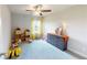 Spacious bedroom with natural light, neutral carpet, ceiling fan, and toys at 532 Walton Dr, Woodstock, GA 30188