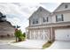 View of a well maintained townhome with two car garage and nicely landscaped front at 532 Walton Dr, Woodstock, GA 30188