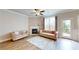 Bright living room with fireplace, hardwood flooring, neutral decor, and natural light at 532 Walton Dr, Woodstock, GA 30188