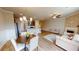Open living space with a kitchen, dining area, living room, and fireplace with exposed brick at 532 Walton Dr, Woodstock, GA 30188