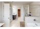 Main bathroom with a dual sink vanity, glass enclosed shower, and a soaking tub at 532 Walton Dr, Woodstock, GA 30188