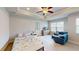 Well-lit main bedroom with a ceiling fan, television, and comfortable seating area at 532 Walton Dr, Woodstock, GA 30188