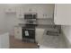 Kitchen features modern appliances, granite countertops, white cabinets, and stainless steel faucet at 991 Park Creek Cir, Lawrenceville, GA 30044