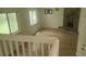 Living room with a stone fireplace, large windows, hardwood floors and modern light fixtures at 991 Park Creek Cir, Lawrenceville, GA 30044