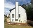 The side of the house has a tall chimney and a manicured lawn at 210 Paris Dr, Lawrenceville, GA 30043