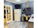 This kitchen features stainless steel appliances, stylish grey cabinets, modern lighting, and a convenient glass door at 210 Paris Dr, Lawrenceville, GA 30043