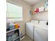 Functional laundry room featuring a washer and dryer, and a window at 210 Paris Dr, Lawrenceville, GA 30043
