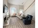 Bright living room featuring a fireplace, comfortable seating, and an abundance of natural light at 210 Paris Dr, Lawrenceville, GA 30043