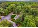 Aerial shot showcasing a home surrounded by a dense green forest, offering privacy and natural beauty at 4716 N Springs Ct, Atlanta, GA 30338