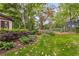 Lush backyard featuring diverse foliage, manicured garden beds, and a serene, private outdoor space at 4716 N Springs Ct, Atlanta, GA 30338