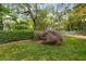 Lush backyard with manicured lawn, mature trees, and privacy hedges, providing a serene outdoor space at 4716 N Springs Ct, Atlanta, GA 30338