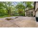 Large backyard area with mature trees, a yellow bench, and landscaping offering potential for outdoor living and entertaining at 4716 N Springs Ct, Atlanta, GA 30338