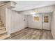 Finished basement with plank flooring, neutral walls, and an exterior door, offering versatility and functionality at 4716 N Springs Ct, Atlanta, GA 30338