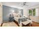 Bedroom with a bed, white rug, and blue accent wall, enhanced by natural light at 4716 N Springs Ct, Atlanta, GA 30338