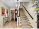 Inviting foyer with staircase, chandelier, and decorative details creating a warm and elegant entrance at 4716 N Springs Ct, Atlanta, GA 30338