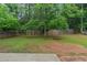 Backyard featuring a mature tree and wooden fence at 589 Arbor Ridge Dr, Stone Mountain, GA 30087