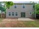 Backyard featuring a sliding door, windows, and concrete patio at 589 Arbor Ridge Dr, Stone Mountain, GA 30087