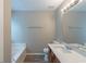 The bathroom has a tub, a toilet, and a vanity with a sink and a large mirror at 589 Arbor Ridge Dr, Stone Mountain, GA 30087