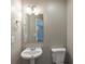 Cozy half bathroom featuring a pedestal sink and modern fixtures at 589 Arbor Ridge Dr, Stone Mountain, GA 30087