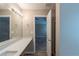 Bathroom vanity with a stylish countertop and a doorway to a bedroom with a ceiling fan at 589 Arbor Ridge Dr, Stone Mountain, GA 30087
