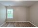 Empty bedroom featuring natural light from a large window and neutral paint to match any decor at 589 Arbor Ridge Dr, Stone Mountain, GA 30087