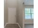 Bright entryway featuring wood-look floors, white door, and abundant natural light at 589 Arbor Ridge Dr, Stone Mountain, GA 30087
