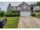 Charming two-story home with lush landscaping, a two-car garage, and welcoming curb appeal at 589 Arbor Ridge Dr, Stone Mountain, GA 30087