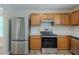 Kitchen with stainless steel refrigerator and appliances at 589 Arbor Ridge Dr, Stone Mountain, GA 30087