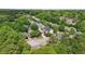 An aerial view shows a neighborhood of homes surrounded by mature, lush trees at 3800 Market Walk, Clarkston, GA 30021