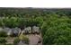 An aerial neighborhood view with mature trees and a distant mountain view, showcasing the beauty of the area at 3800 Market Walk, Clarkston, GA 30021