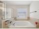 Bathroom featuring a large soaking tub with tile surround, and a separate glass shower at 3800 Market Walk, Clarkston, GA 30021