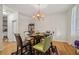 Cozy dining room features hardwood floors, chandelier, and seating for six at 3800 Market Walk, Clarkston, GA 30021