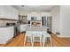 Bright kitchen features an island, stainless appliances, white cabinets, and granite countertops at 3800 Market Walk, Clarkston, GA 30021
