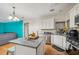 Open kitchen with island, stainless steel appliances, granite countertops, and hardwood floors at 3800 Market Walk, Clarkston, GA 30021