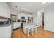 Bright kitchen features an island, stainless appliances, white cabinets, and granite countertops at 3800 Market Walk, Clarkston, GA 30021
