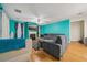 Bright living room with hardwood floors, a fireplace, a fan, and a large sectional sofa at 3800 Market Walk, Clarkston, GA 30021