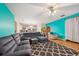 Spacious living room featuring a large sectional couch, ceiling fan, and open floor plan leading to the kitchen at 3800 Market Walk, Clarkston, GA 30021