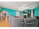 Cozy living room with hardwood floors, a fireplace, a ceiling fan, and a blue accent wall at 3800 Market Walk, Clarkston, GA 30021
