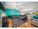 Open living space with hardwood floors, a fireplace, a ceiling fan, and a turquoise accent wall at 3800 Market Walk, Clarkston, GA 30021
