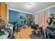 Unkempt room with blue accent wall, hardwood floors, and salon equipment at 3800 Market Walk, Clarkston, GA 30021