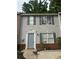 Charming two-story home with gray siding and a decorative doorframe at 5574 Fair Creek Way, Lithonia, GA 30038