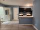 Open concept kitchen with black cabinets, a breakfast bar and tile flooring at 5574 Fair Creek Way, Lithonia, GA 30038