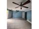 Spacious living room with a ceiling fan and tile flooring at 5574 Fair Creek Way, Lithonia, GA 30038