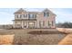 Charming two-story brick home with a welcoming front porch and beautiful architectural details at 727 Hedwig Dr, Mcdonough, GA 30252