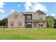Charming brick two-story home with a well-manicured front lawn at 727 Hedwig Dr, Mcdonough, GA 30252