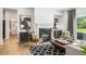 Living room with hardwood floors, fireplace, gray couch, chairs, and modern decor at 727 Hedwig Dr, Mcdonough, GA 30252