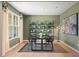 Office featuring green walls, black table and chairs, a standing lamp, and black shelving at 727 Hedwig Dr, Mcdonough, GA 30252