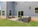 Back patio with outdoor seating and sliding glass door to the home at 727 Hedwig Dr, Mcdonough, GA 30252