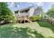 Spacious backyard featuring a deck, green lawn, and privacy fence at 900 Meadowsong Cir, Lawrenceville, GA 30043