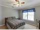 This is a cozy bedroom with a ceiling fan and a window providing natural light at 900 Meadowsong Cir, Lawrenceville, GA 30043